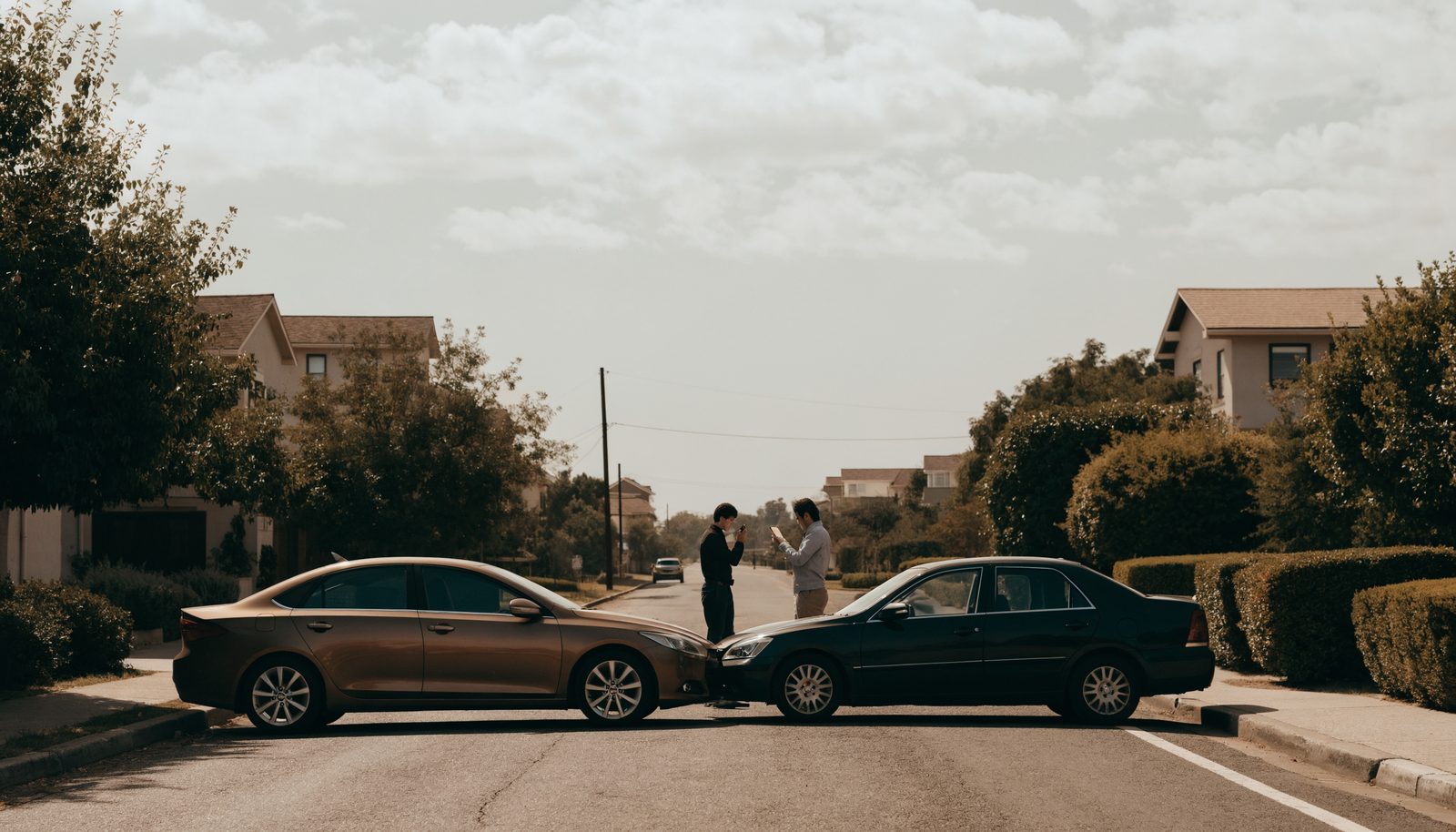 Two drivers exchanging information after a minor collision